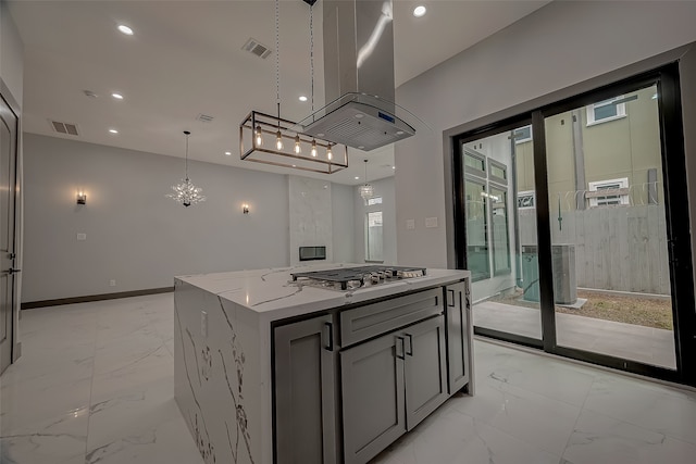 kitchen with stainless steel gas cooktop, pendant lighting, light tile patterned floors, island exhaust hood, and a center island