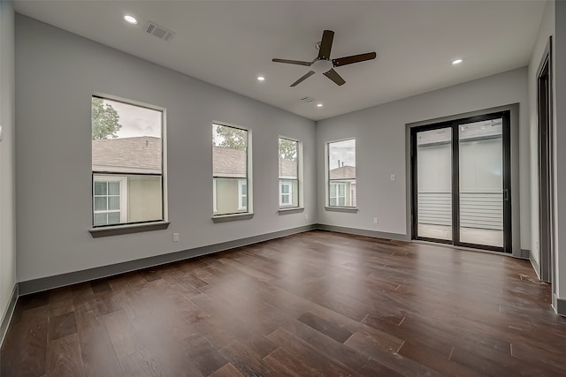 empty room featuring dark wood-type flooring and ceiling fan