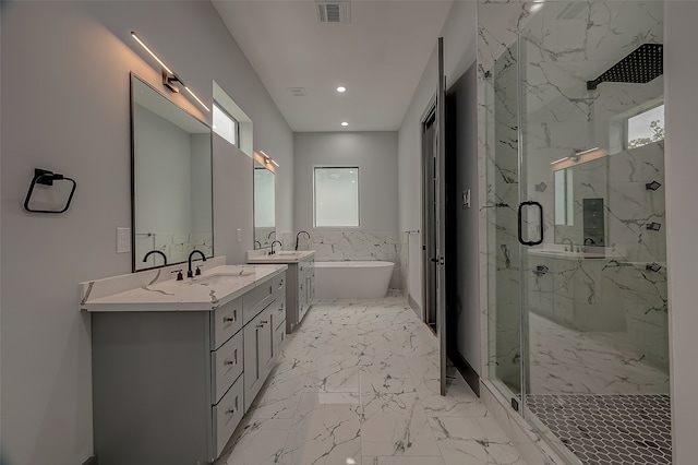 bathroom featuring a shower with shower door, dual vanity, and tile patterned floors