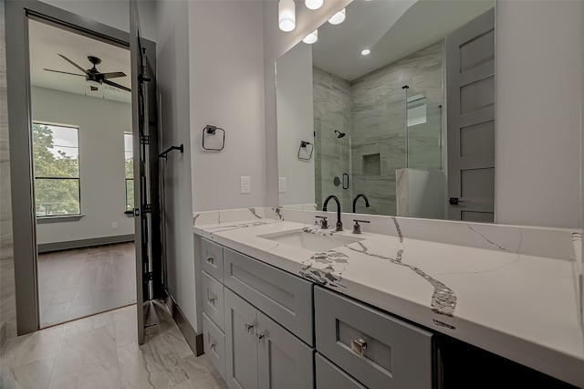 bathroom with hardwood / wood-style flooring, a shower with shower door, vanity, and ceiling fan