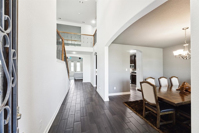 entrance foyer featuring dark wood-type flooring and a notable chandelier