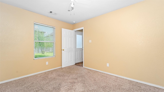 carpeted empty room featuring ceiling fan