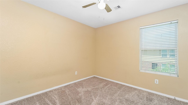 unfurnished room featuring ceiling fan and carpet