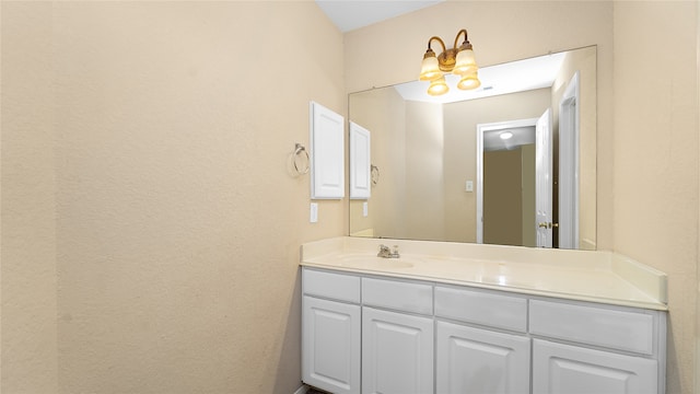 bathroom featuring vanity and a chandelier