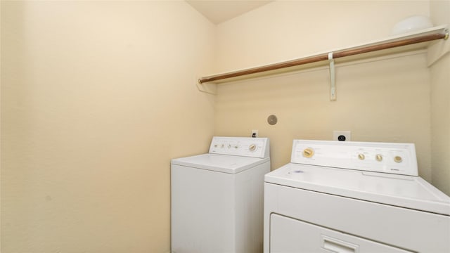 clothes washing area featuring independent washer and dryer