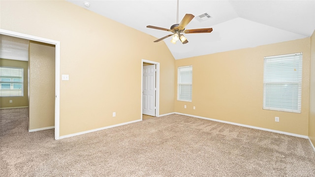 unfurnished bedroom featuring lofted ceiling, light carpet, and ceiling fan