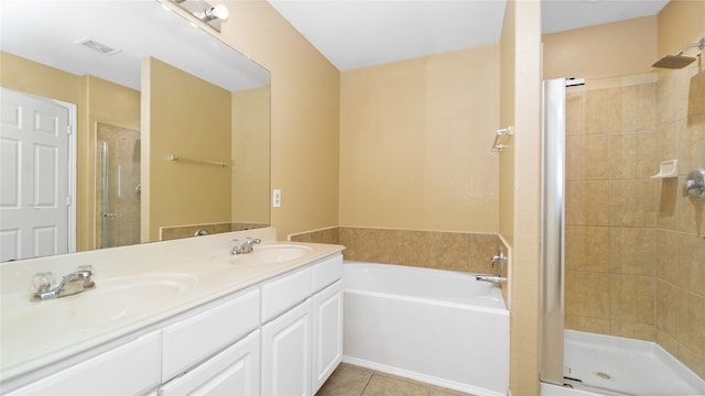 bathroom featuring plus walk in shower, dual vanity, and tile patterned floors