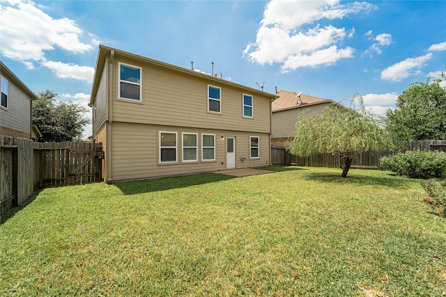 rear view of property with a patio area and a yard