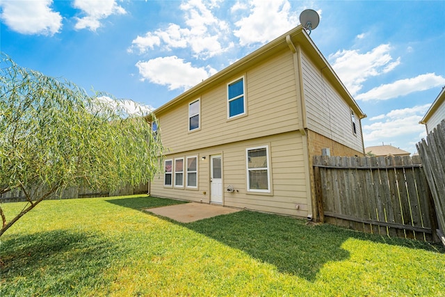 back of property featuring a patio and a yard