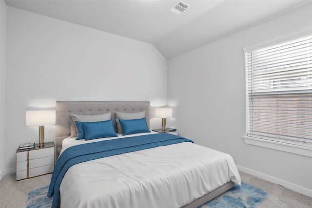 bedroom featuring light carpet and vaulted ceiling