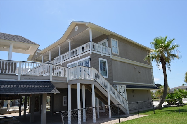 rear view of house featuring a balcony and a carport