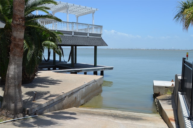 view of dock with a pergola and a water view