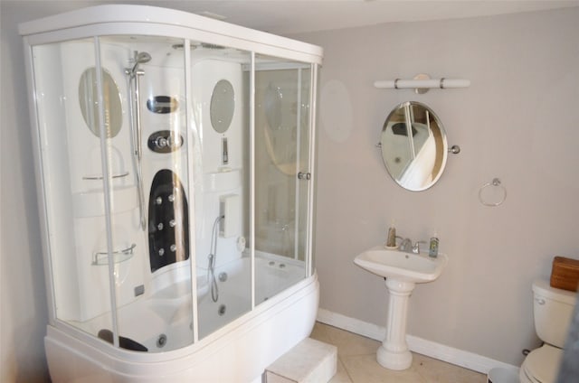 bathroom featuring combined bath / shower with glass door, toilet, and tile patterned floors