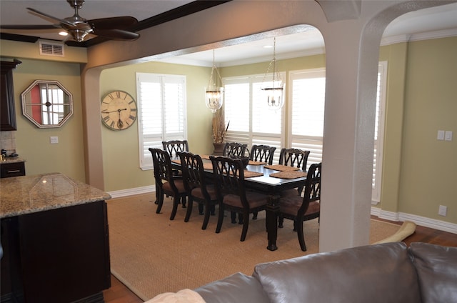 dining room featuring ornamental molding, ceiling fan with notable chandelier, and hardwood / wood-style floors