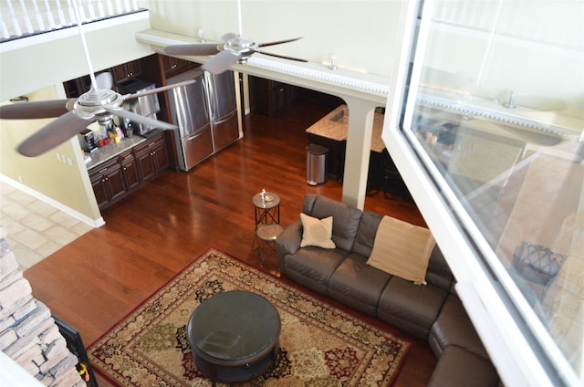 living room with wood-type flooring and ceiling fan