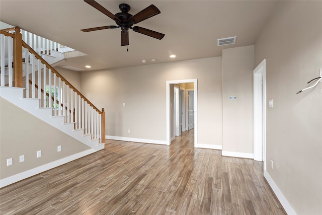 unfurnished living room with light wood-type flooring and ceiling fan