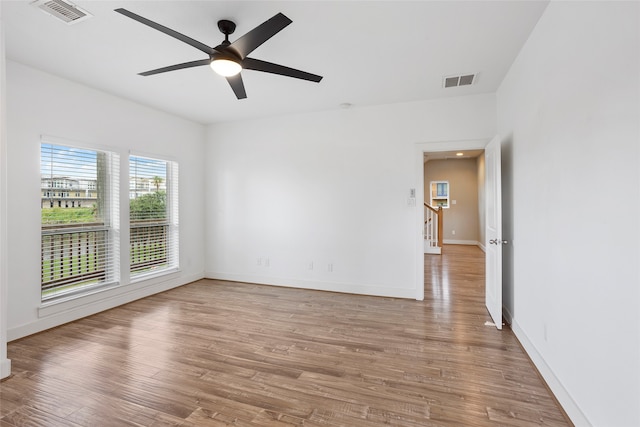 empty room with light hardwood / wood-style flooring and ceiling fan