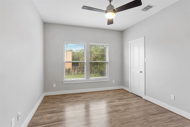 spare room with light hardwood / wood-style floors and ceiling fan