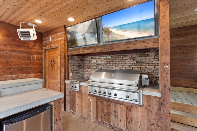 view of patio / terrace featuring exterior kitchen and a grill