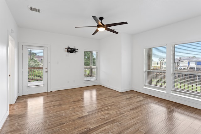 unfurnished room with hardwood / wood-style flooring and ceiling fan