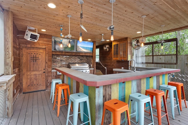 bar with wooden walls and hardwood / wood-style floors