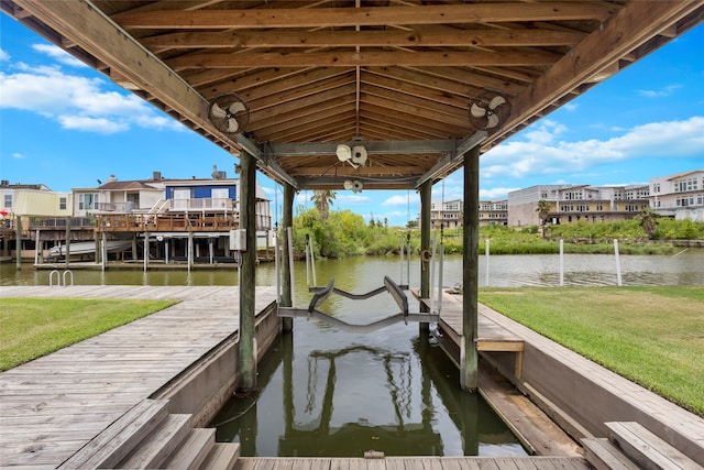 dock area with a yard and a water view