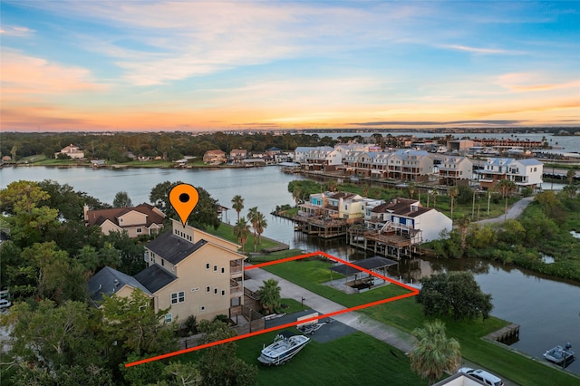 aerial view at dusk with a water view