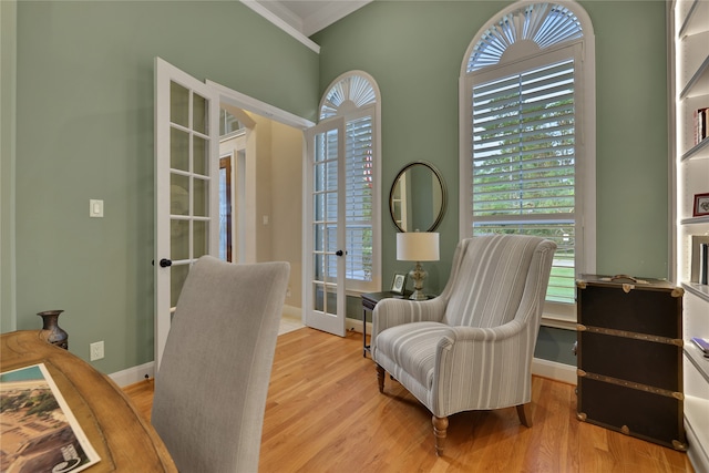 office area with light hardwood / wood-style flooring, french doors, and crown molding