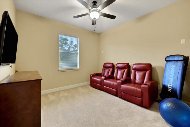 carpeted cinema featuring ceiling fan