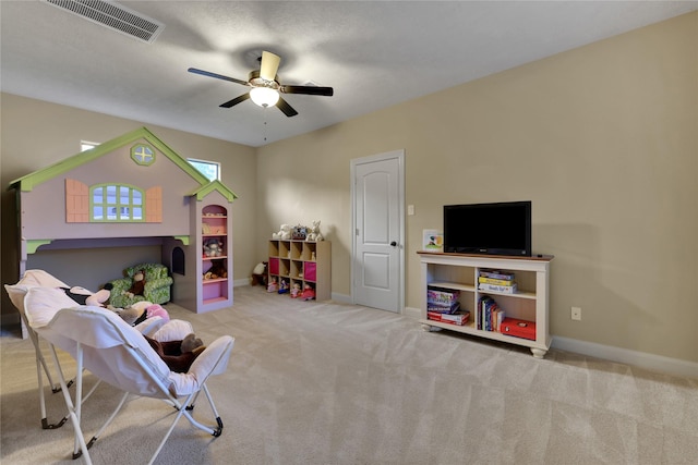 recreation room with ceiling fan and light colored carpet