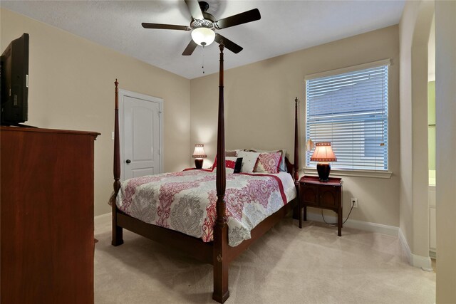 bedroom featuring light carpet and ceiling fan