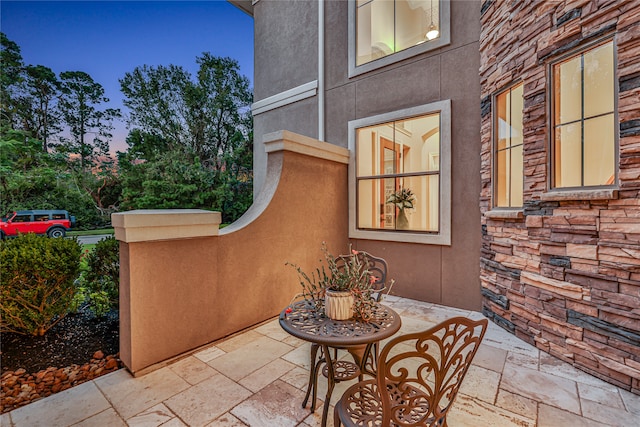 view of patio terrace at dusk