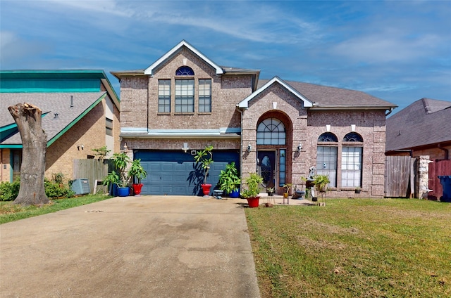 view of front of property with a garage, central AC, and a front yard