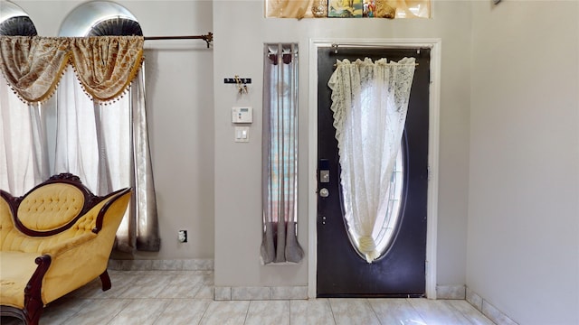 foyer entrance with light tile patterned floors