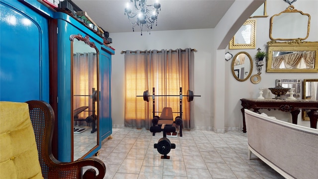 interior space with light tile patterned flooring and an inviting chandelier