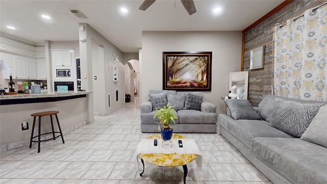 living room featuring light tile patterned flooring and ceiling fan