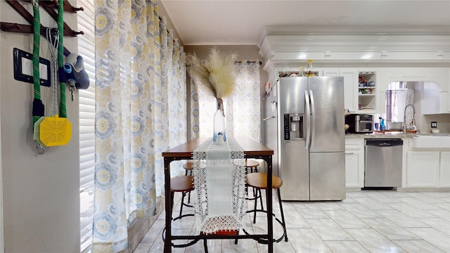 kitchen featuring white cabinetry, light tile patterned flooring, and stainless steel appliances