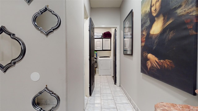 hall featuring washer / dryer and light tile patterned floors