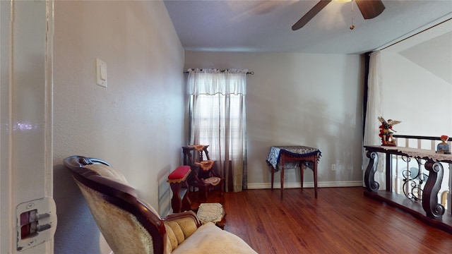 sitting room with ceiling fan and hardwood / wood-style flooring