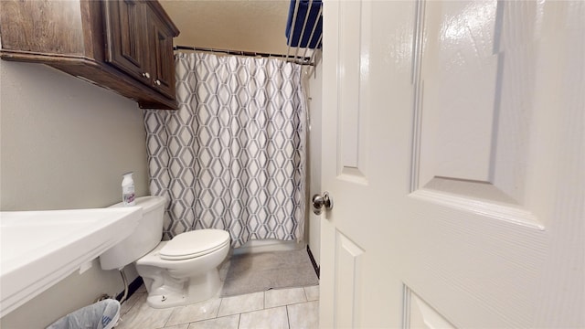 bathroom with tile patterned floors and toilet