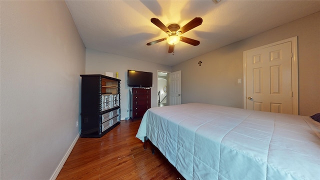 bedroom with dark wood-type flooring and ceiling fan