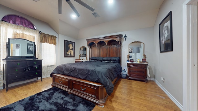 bedroom with ceiling fan, light hardwood / wood-style flooring, and lofted ceiling