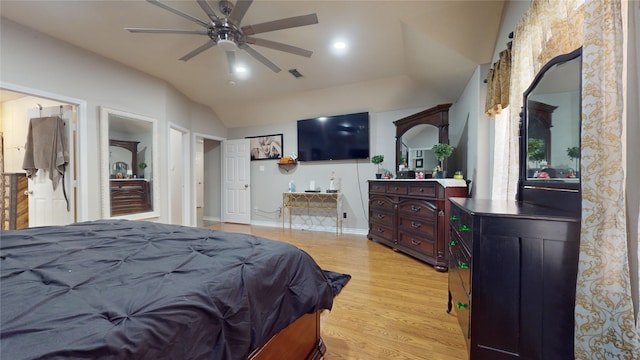 bedroom with light hardwood / wood-style flooring, ceiling fan, and lofted ceiling