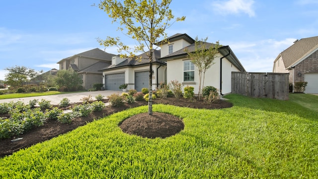 view of front of property with a garage and a front yard