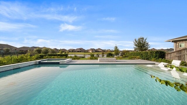 view of pool featuring an in ground hot tub and a patio