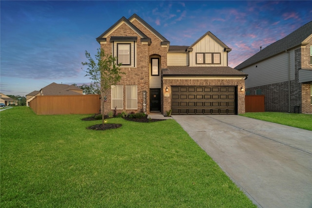 view of front of house featuring board and batten siding, a front yard, concrete driveway, and fence