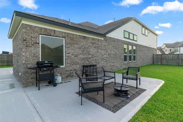 back of house with a patio, an outdoor fire pit, and a lawn