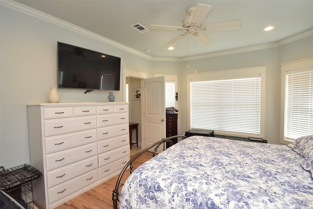 bedroom with crown molding, ceiling fan, and light wood-type flooring