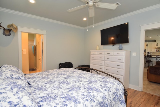 bedroom featuring ornamental molding, ceiling fan, and light hardwood / wood-style flooring