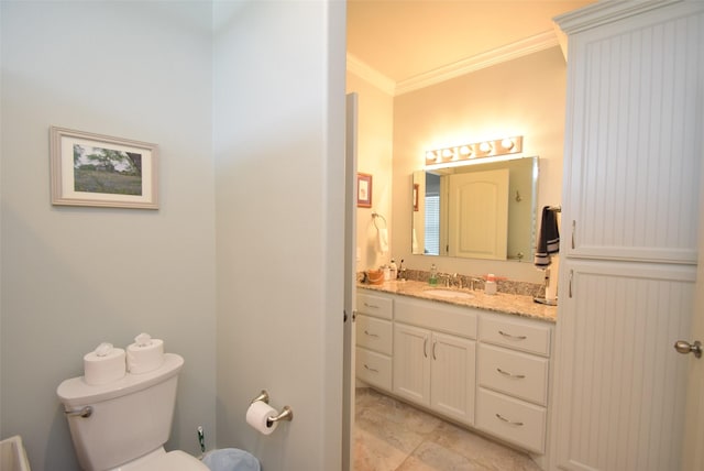 bathroom with crown molding, vanity, and toilet